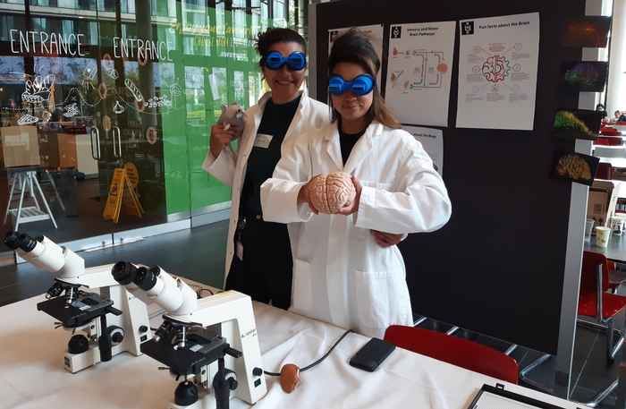 Two SILS neuroscientists showing their stall